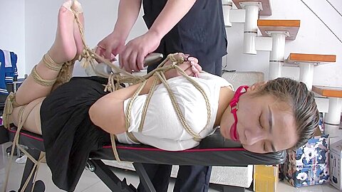 Slender Asian Girl With Sexy Legs Is Introduced To Bondage